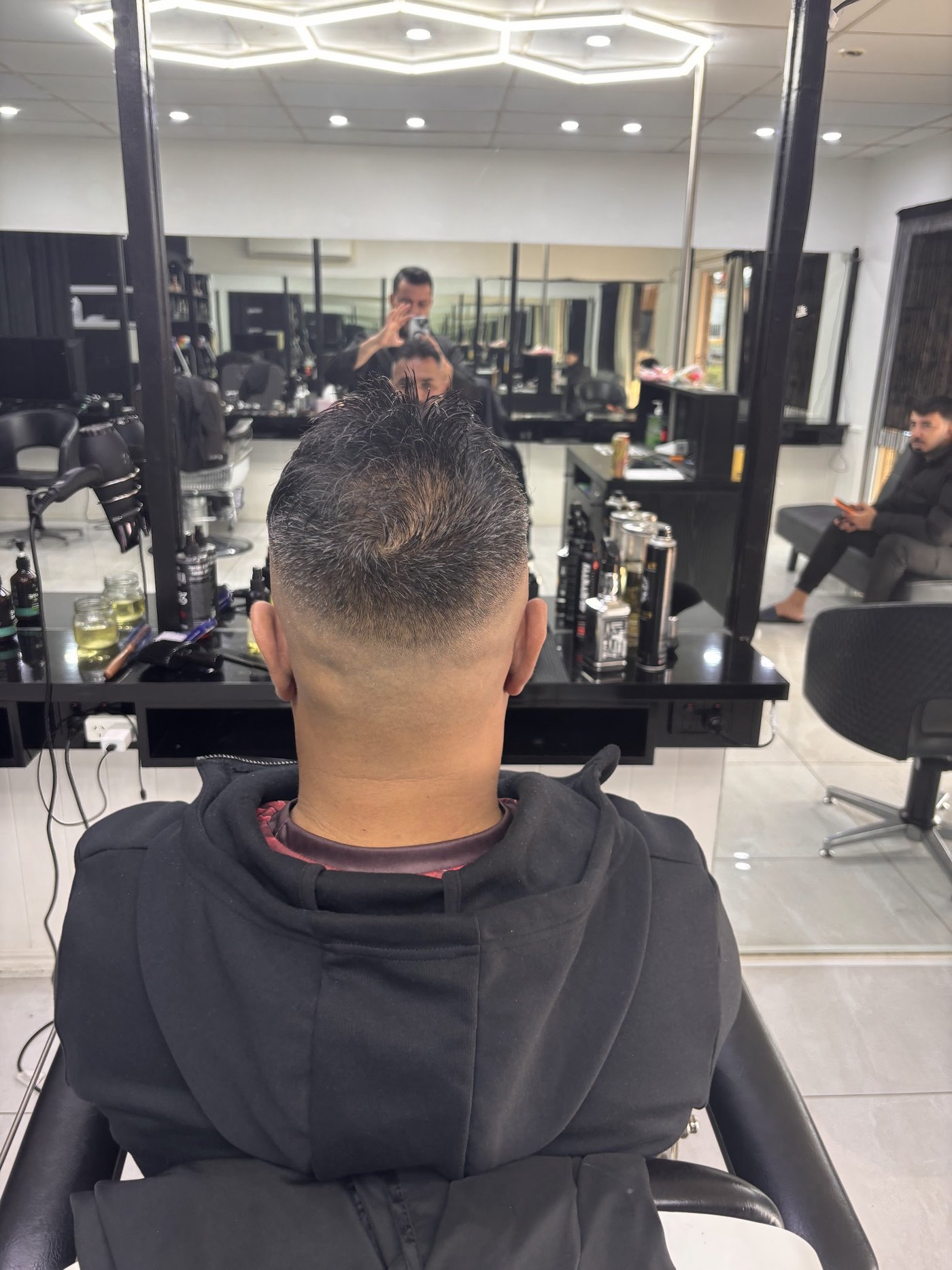 A fresh skin fade seen from behind, in the chair at Toowoomba Barber Shop